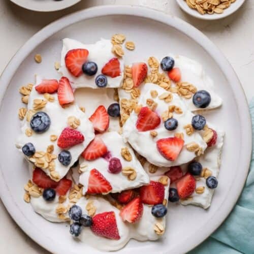 Frozen Yogurt Bark with Fruits and Nuts on. plate stacked