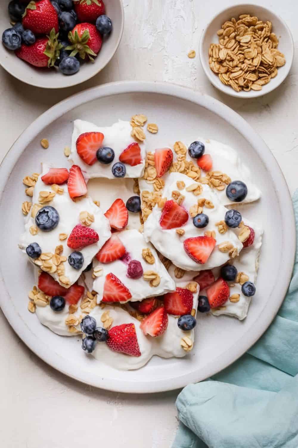 Frozen Yogurt Bark with Fruits and Nuts on. plate stacked